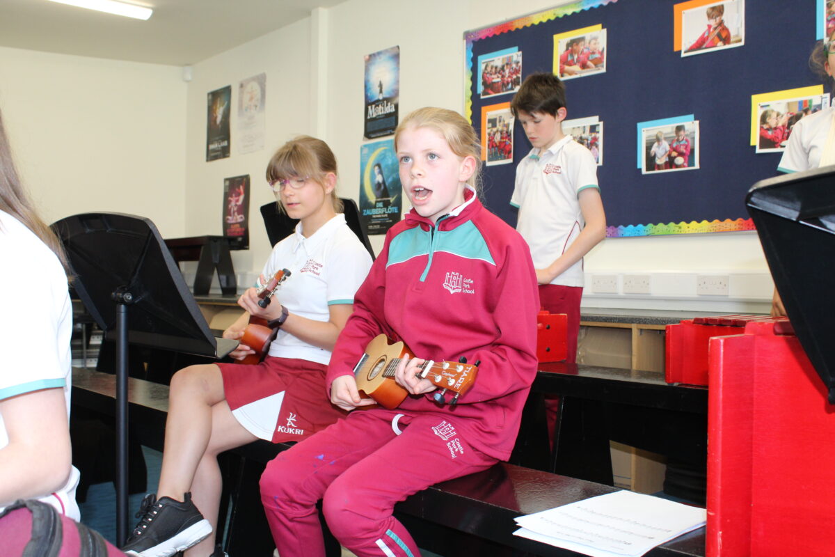 A pupil singing and playing the Ukulele 