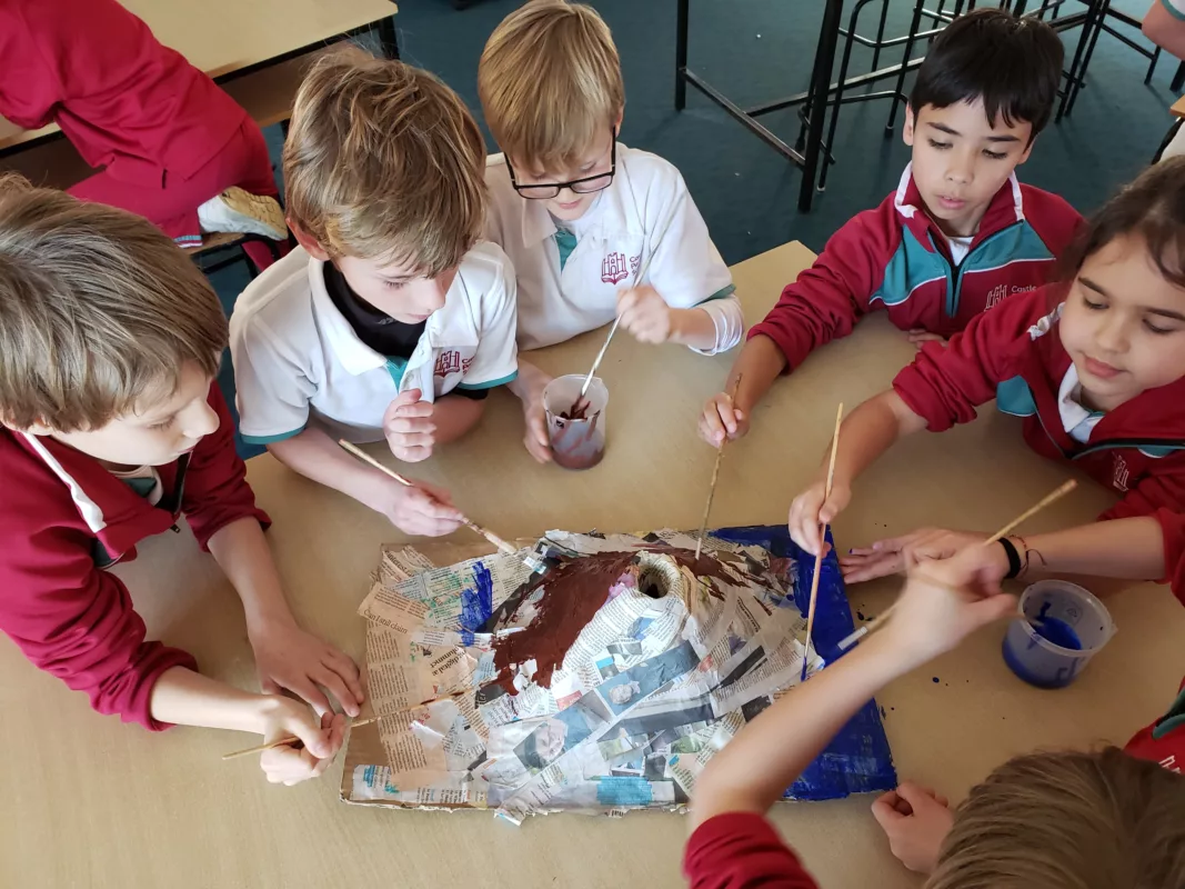 A group of pupils working on a model volcano project as a team