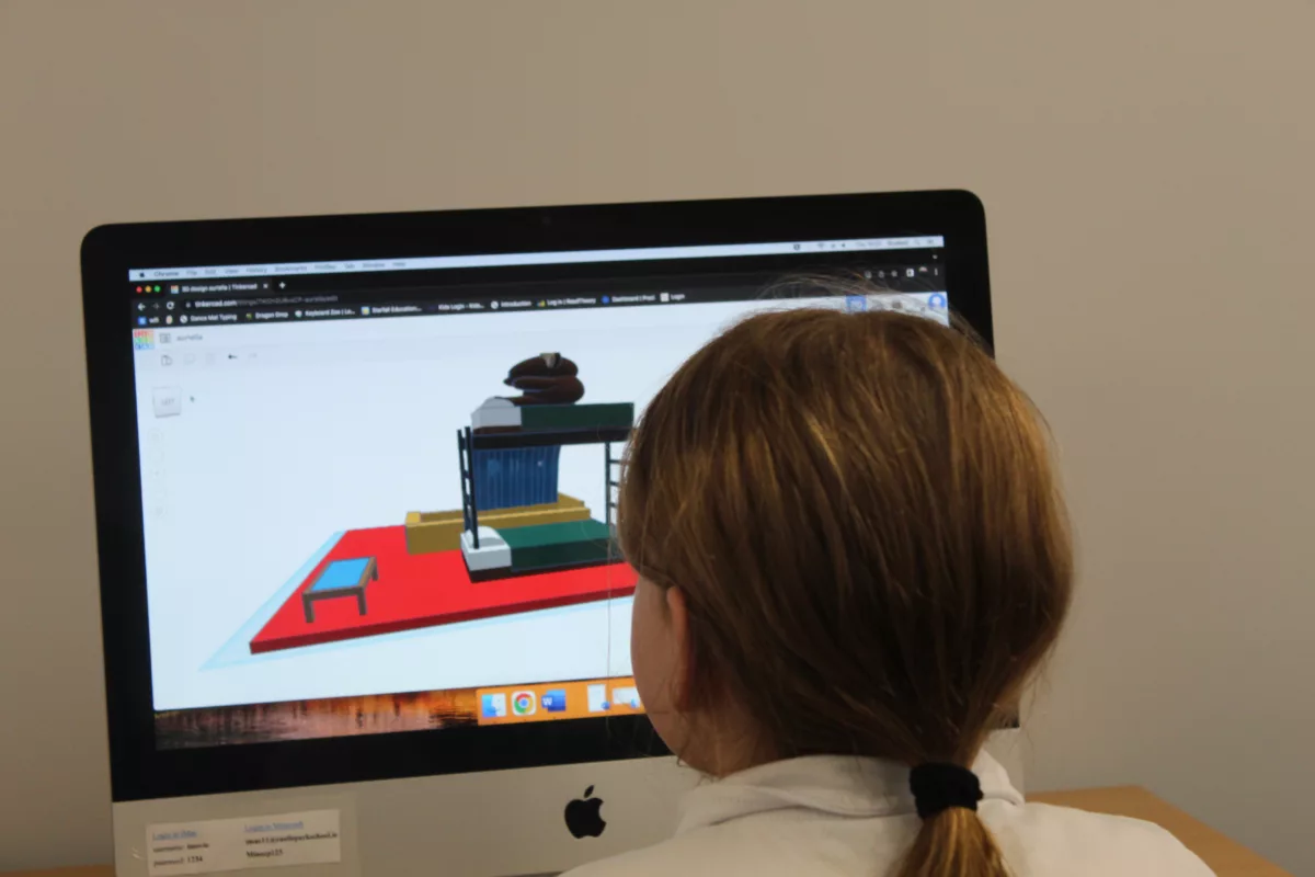 A female pupil working on a design game on a Mac in the ICT Room