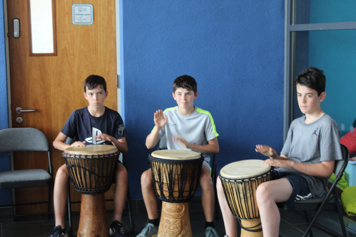 Form VI banging the drums at the drumming workshop