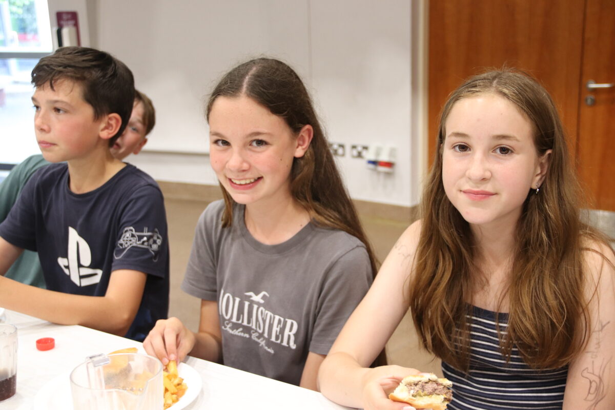 Form VI children enjoying burgers together