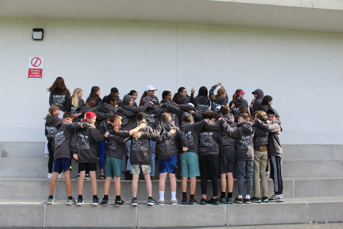 Our form VI pupils with their graduation hoodies in a huddle