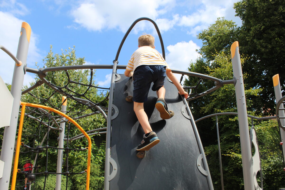 Summer Camp Child Climbing in the adventure playground